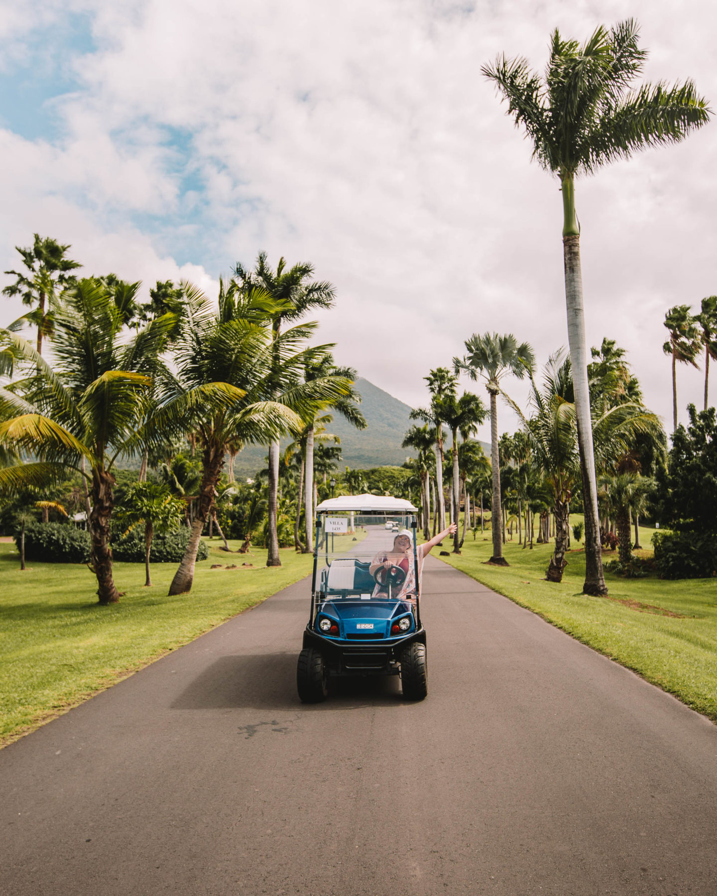 driving a golf cart with nevis peak in the background at four seasons resort nevis