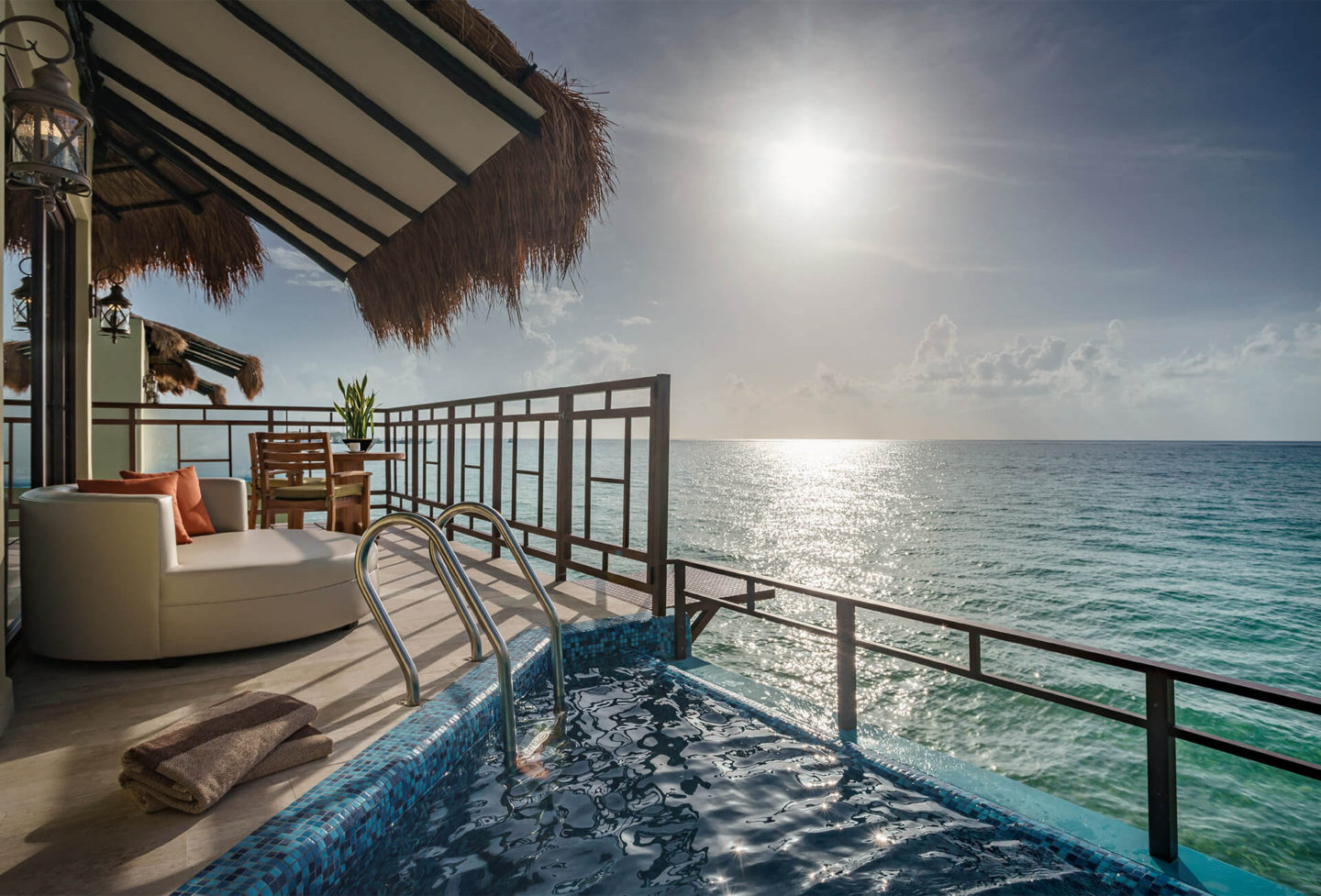 looking out from overwater bungalows in the caribbean palafitos el dorado maroma