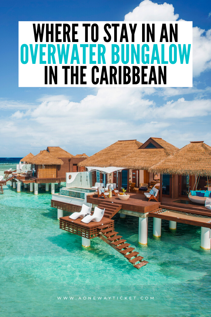 overwater bungalow in the caribbean over bright blue water with blue skies