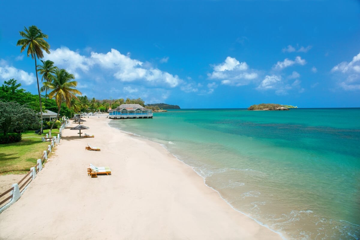 white sand beach with crystal clear blue water at sandals halcyon beach st lucia