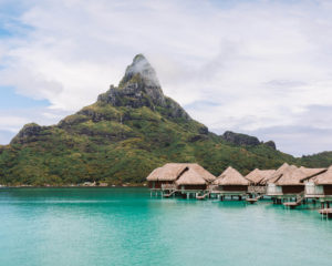 intercontinental thalasso resort's view of mount otemanu with overwater bungalows lining the bottom of the mountain on the right side