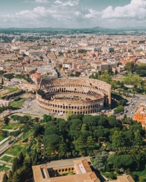 aerial view of the colosseum in rome, a stop on an italy honeymoon itinerary