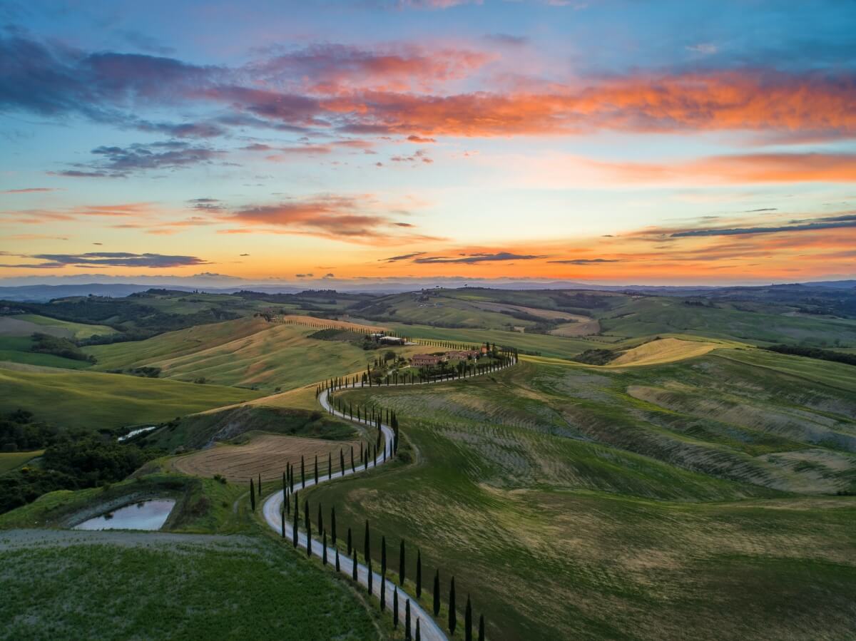 sunset over tuscany's rolling hills italy honeymoon itinerary
