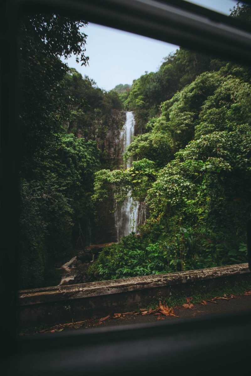 looking at a waterfall through a car window in hawaii