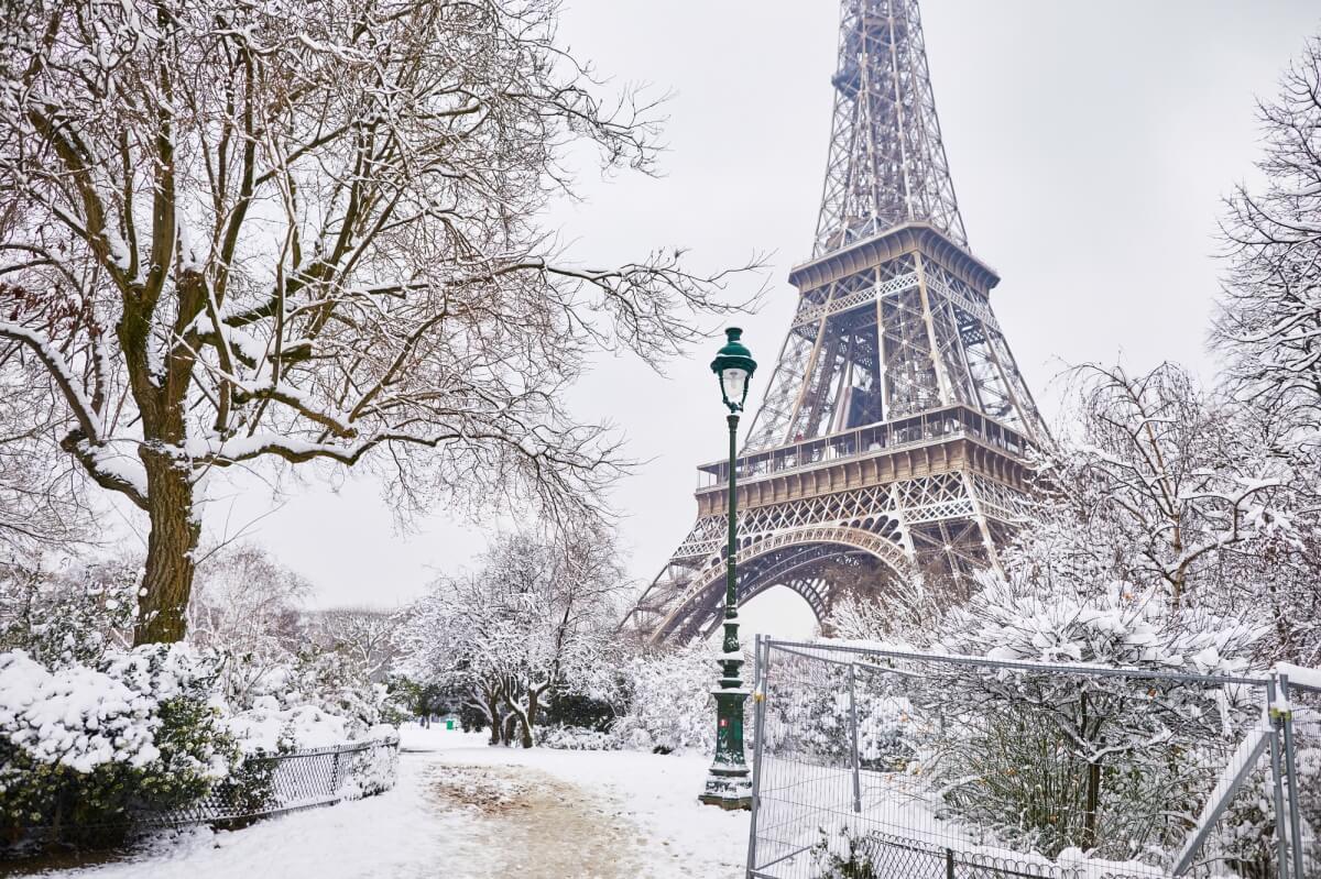 snowy view of paris and the eiffel tower during winter