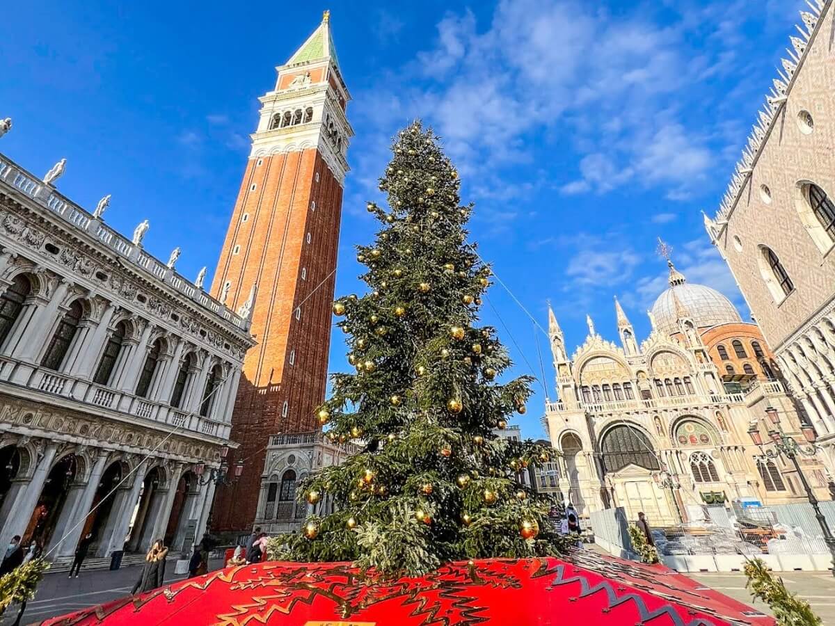 decorated christmas tree in the center of st mark's square in venice italy with blue skies