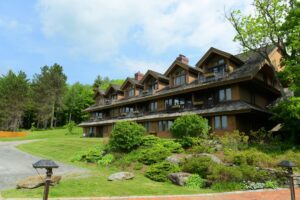 the alpine-looking Trapp Family Lodge hotel in Stowe VT surrounded by lots of greenery and trees