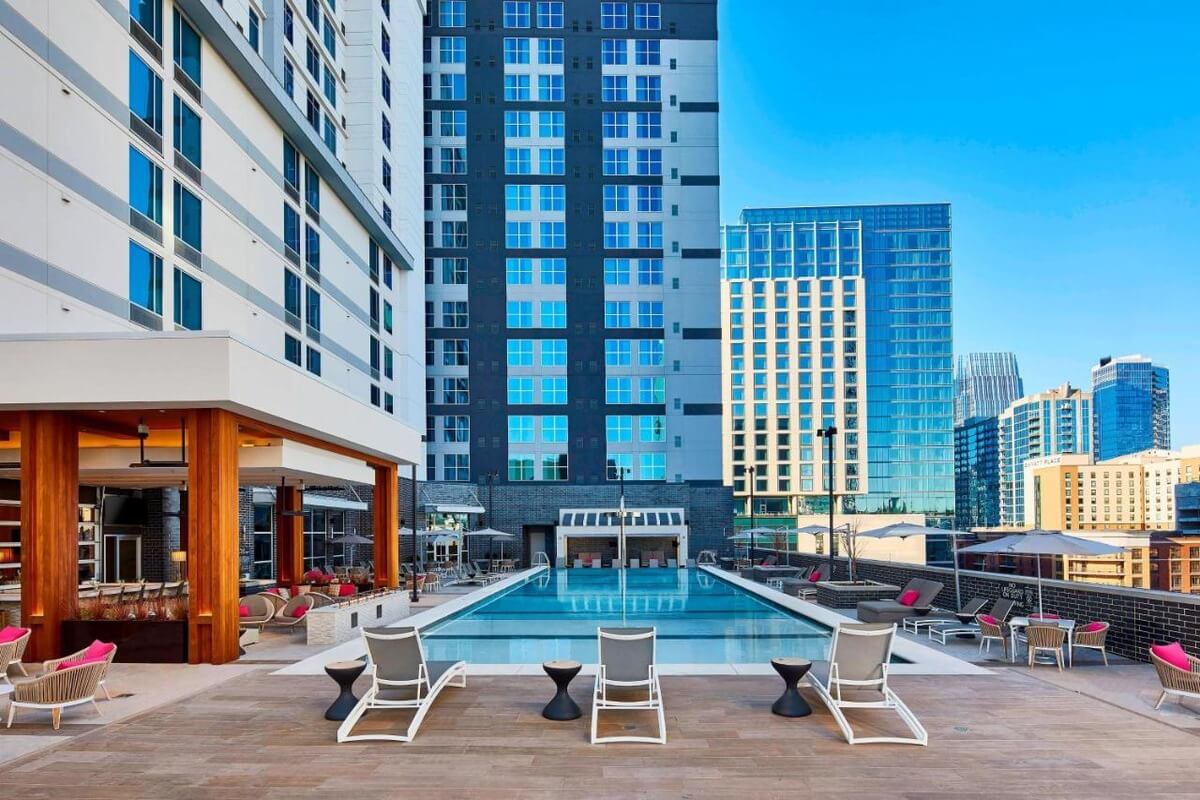 pool deck at the AC Hotel in Downtown Nashville with chairs and a bar on the deck area